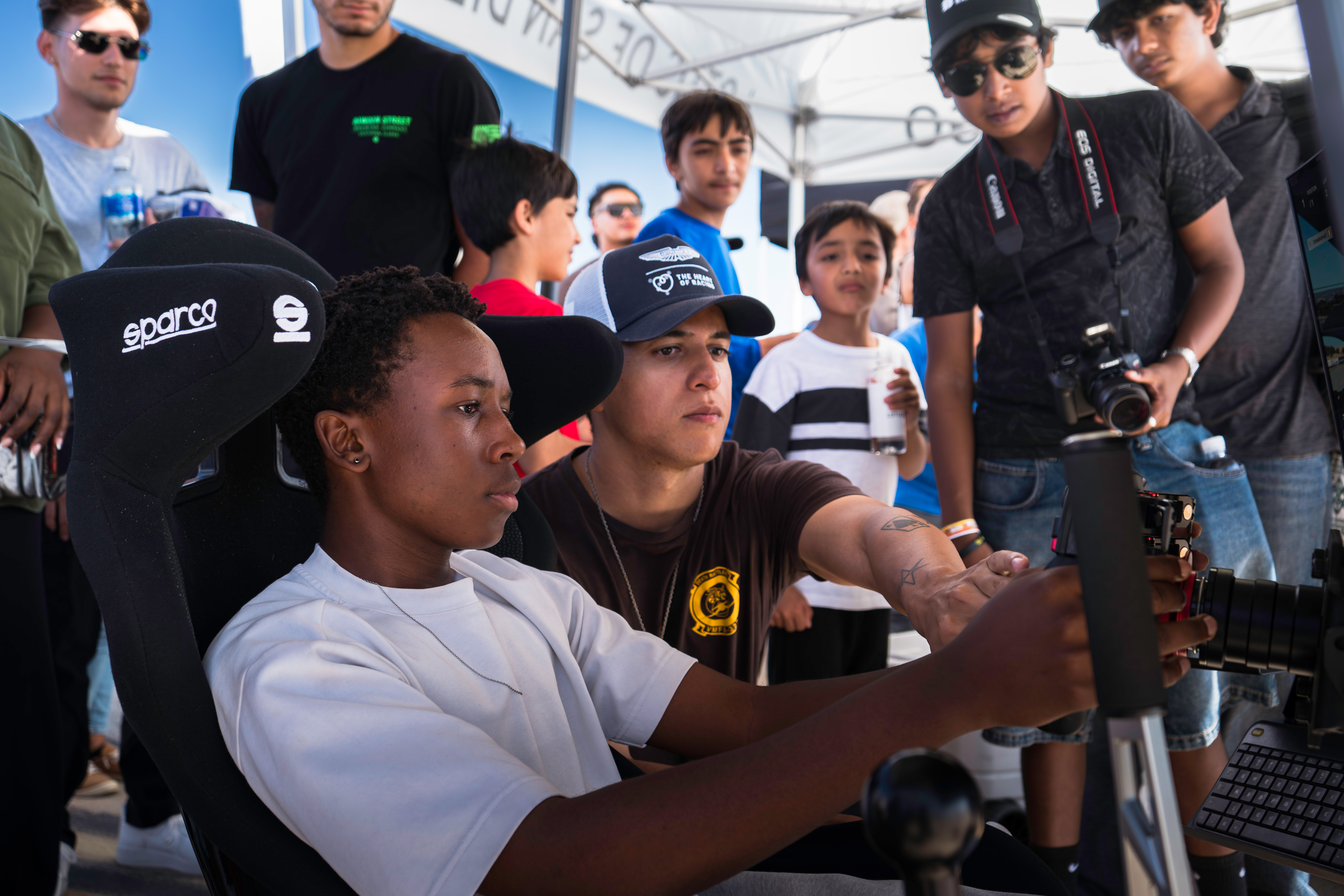 Crowd watching sim racing at outdoor car event