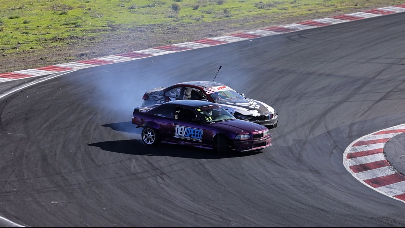 DevSpeed and BMW tandem drifting through banked corner