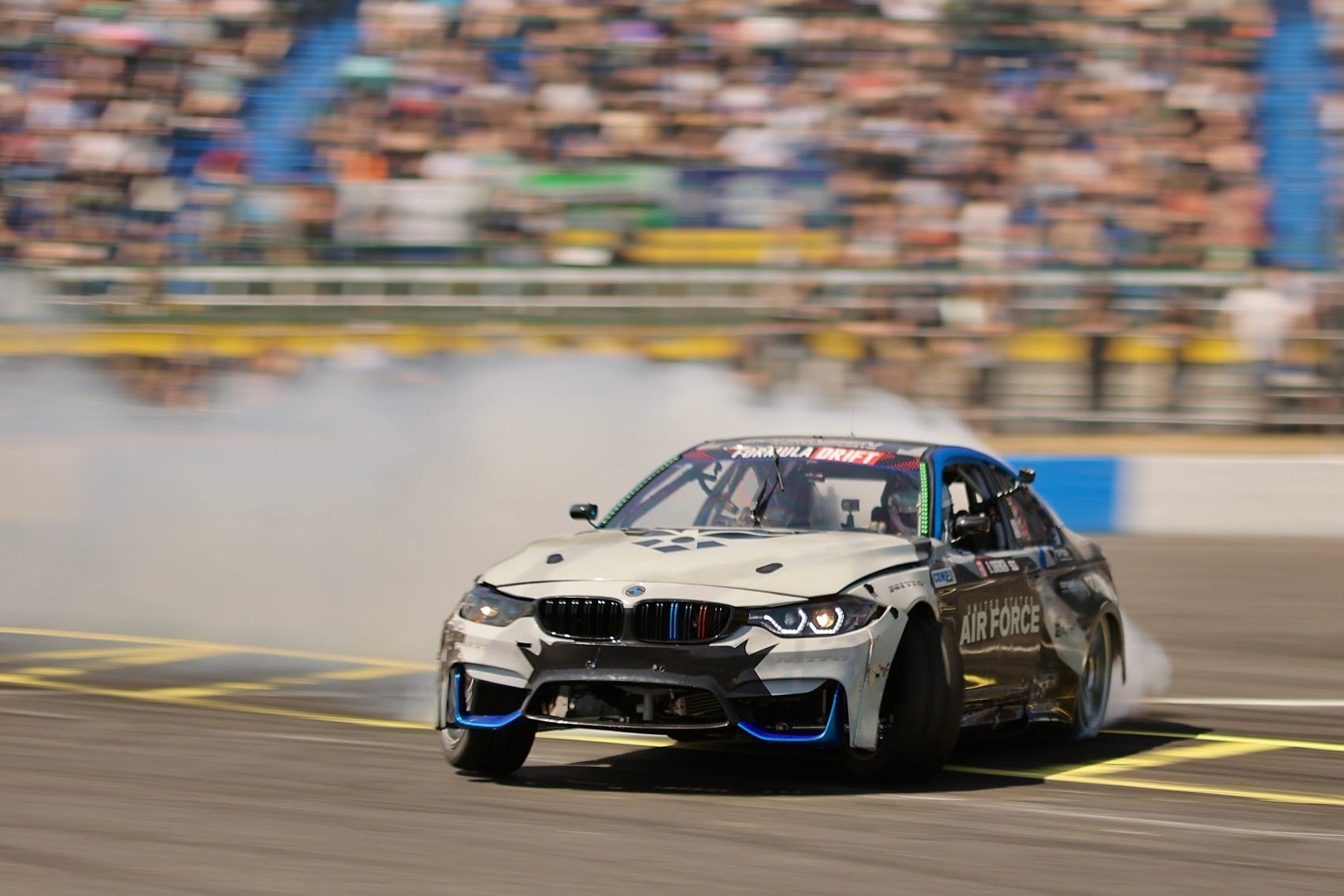 Sorensen Motorsports Air Force BMW M4 drifting at Formula Drift with packed grandstands