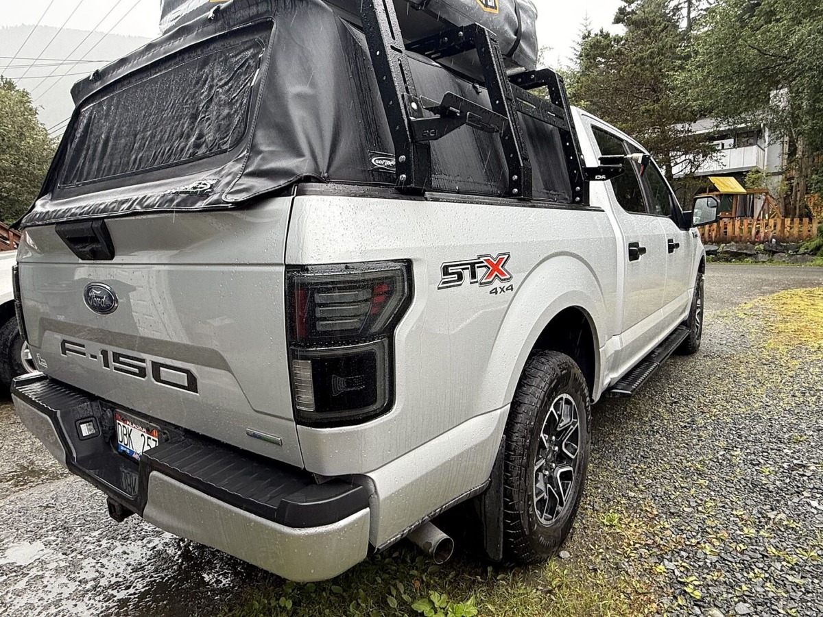 Silver F-150 STX 4x4 with rooftop tent and Morimoto smoked tail lights