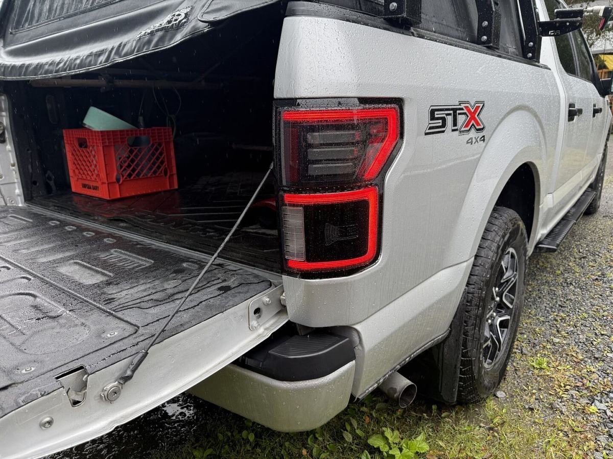 Morimoto XB LED Tail Light close-up with red lens trim ring on silver F-150