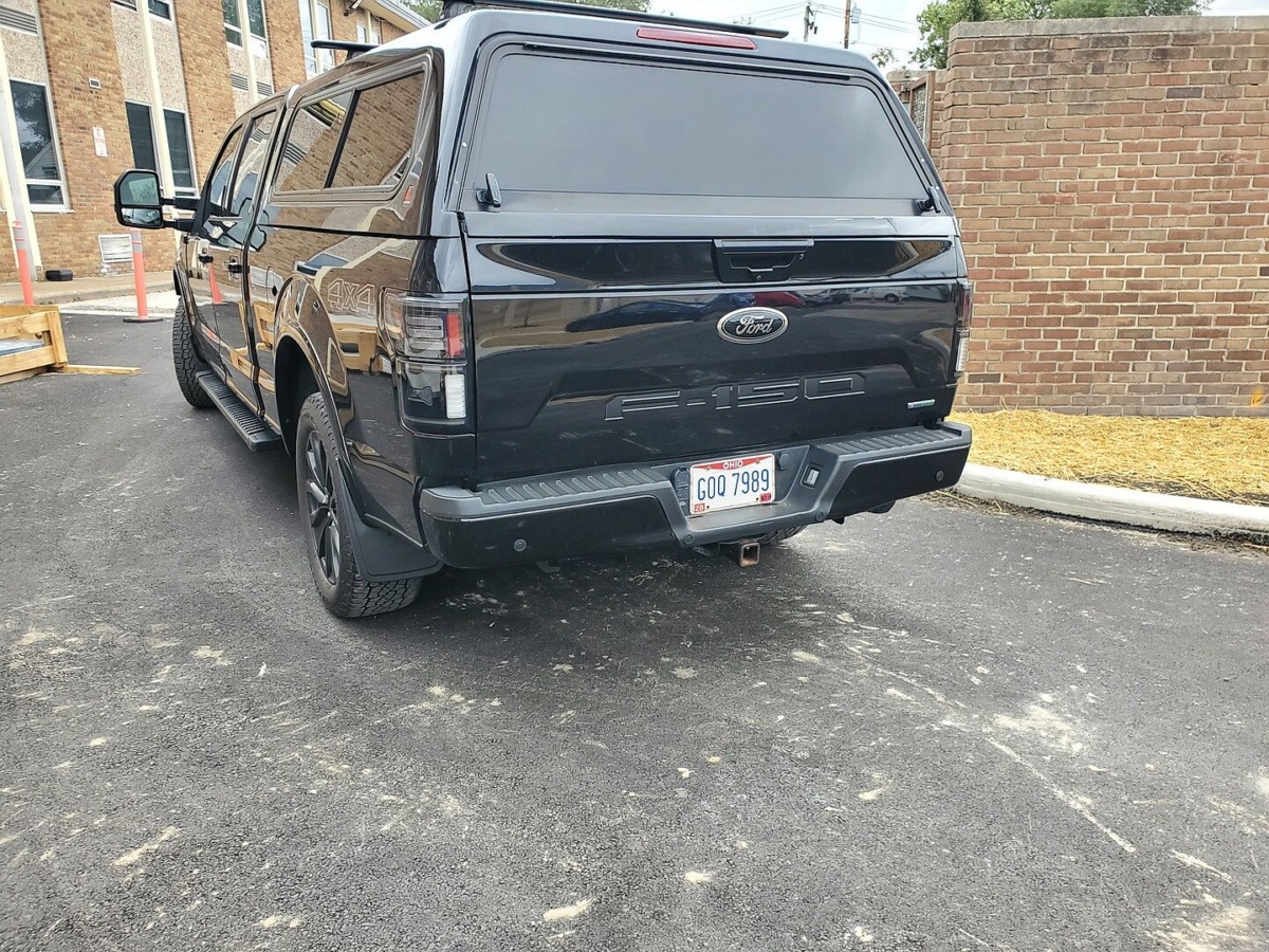 Black F-150 with bed cap and Morimoto smoked XB LED tail lights