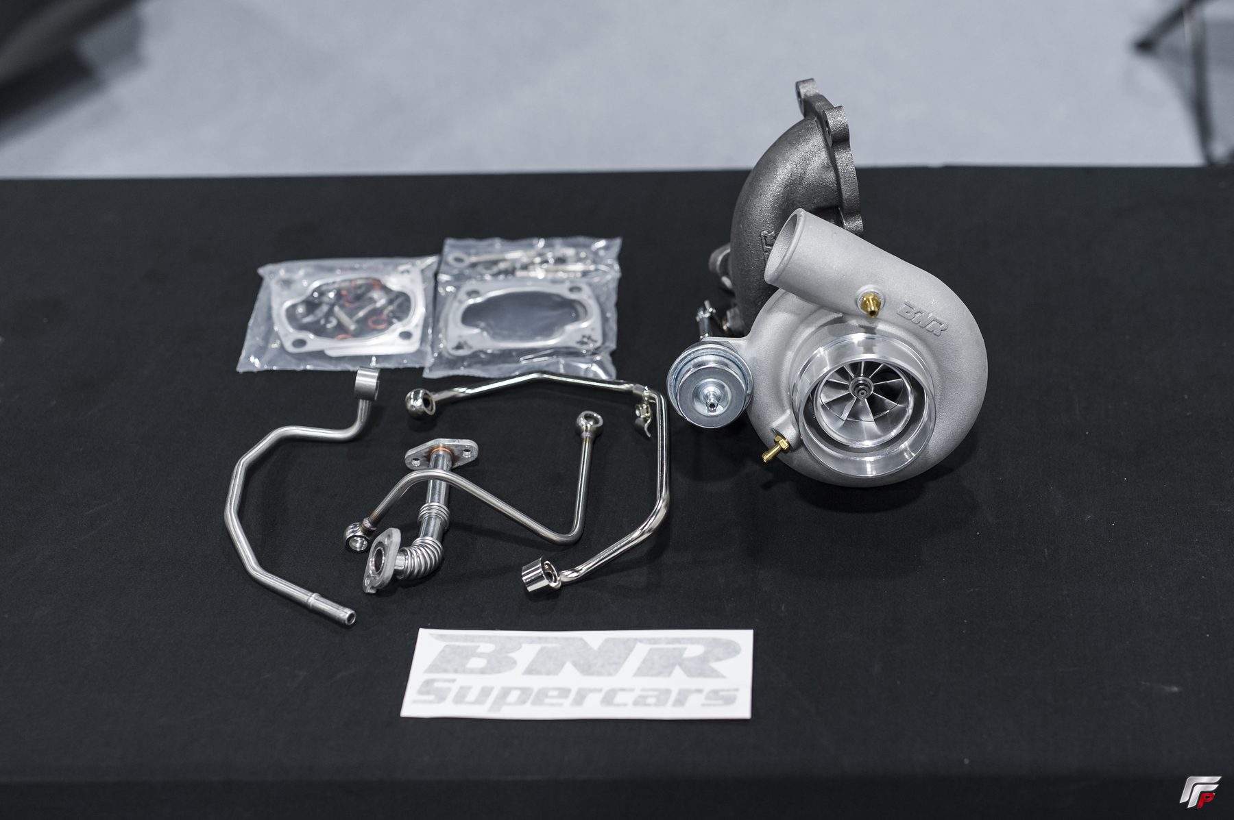 Complete BNR 600 V2 install kit laid out — turbo, stainless lines, gaskets, hardware