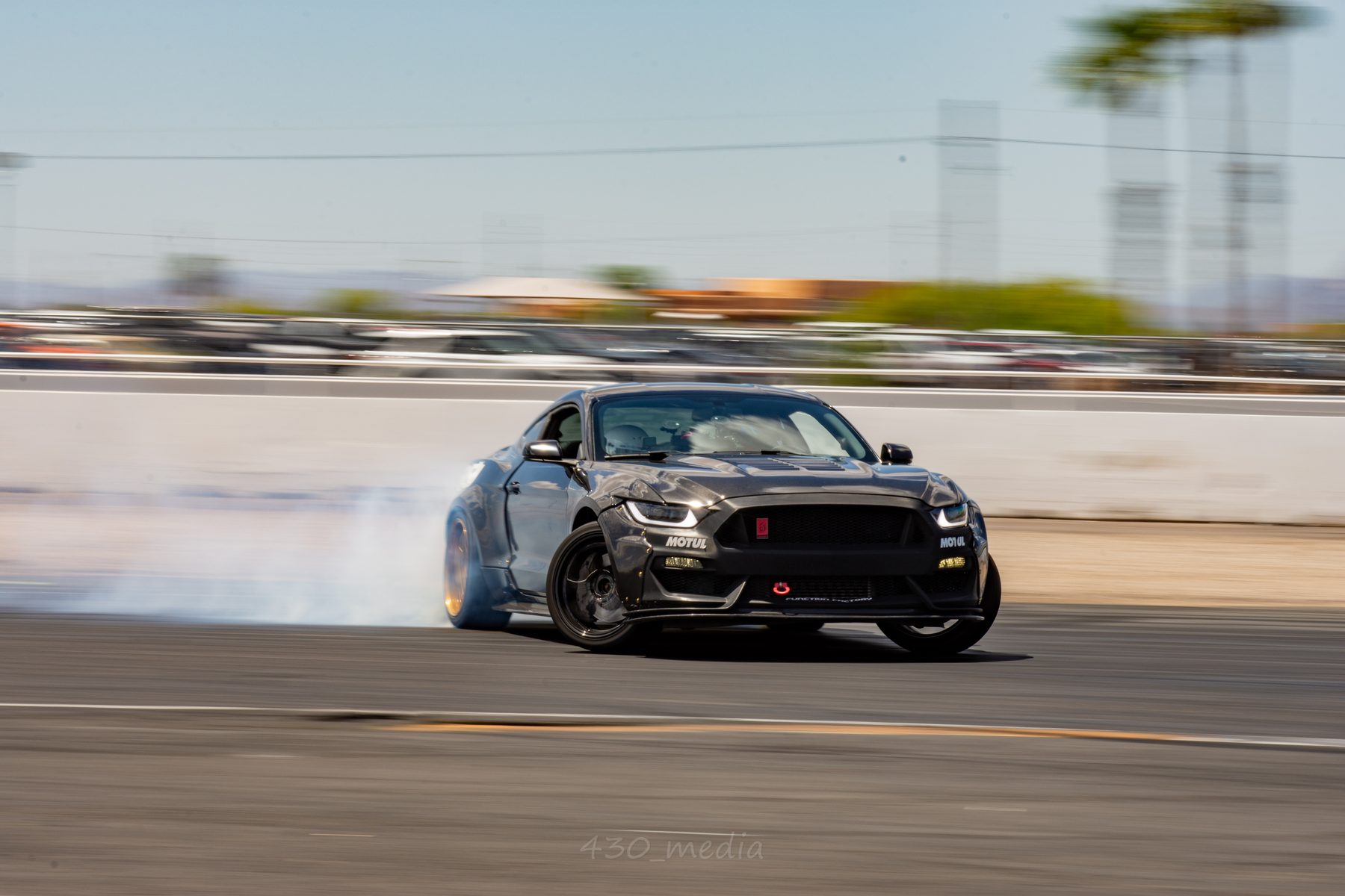 Charles's FFP Mustang sliding at a daytime track event with BNR 600 V2 boost smoke