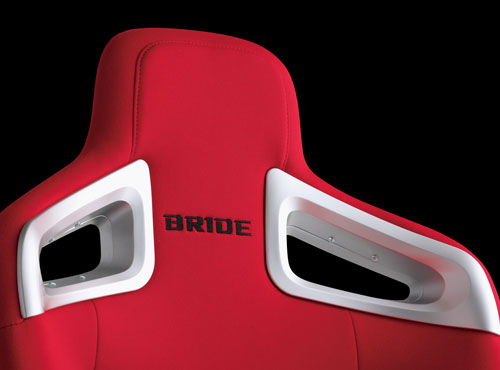 BRIDE A.i.R. seat back belt holes with silver BRIDE branding plates and 3D stream design