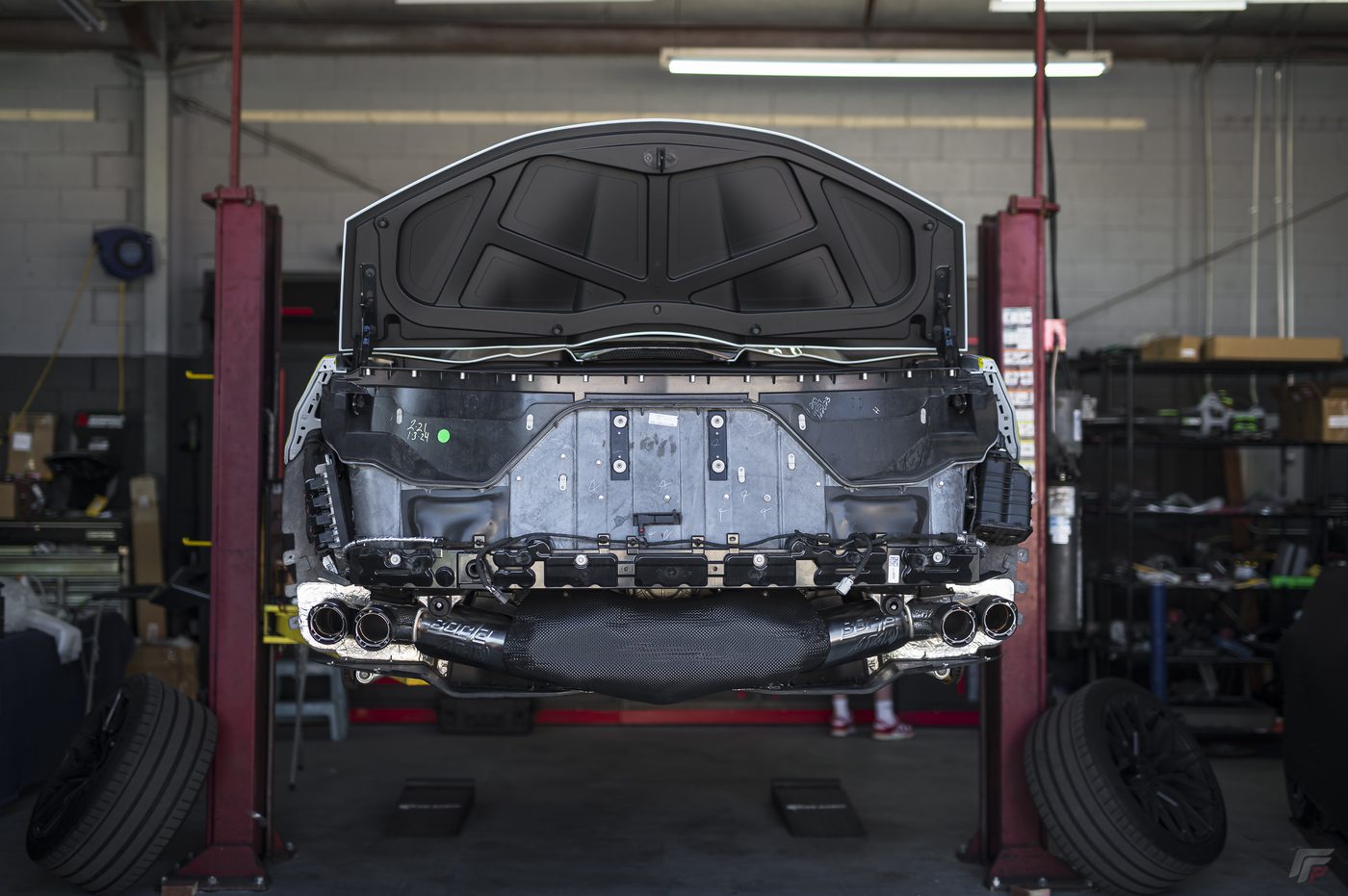 C8 Corvette Stingray on the lift in the FFP Thousand Oaks install bay with quad polished tips visible