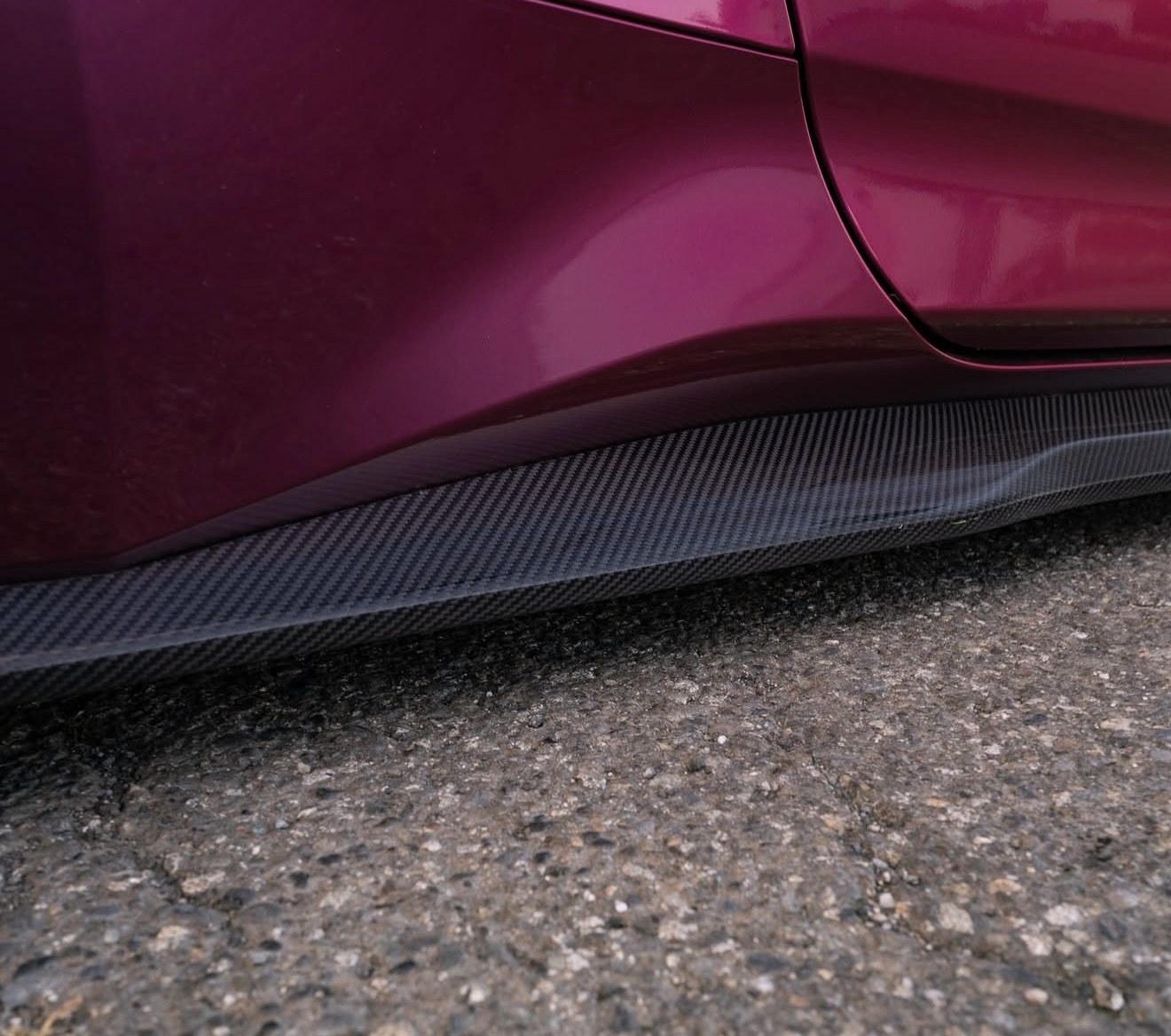 Close-up of the carbon fiber weave on the installed S650 side skirt extension